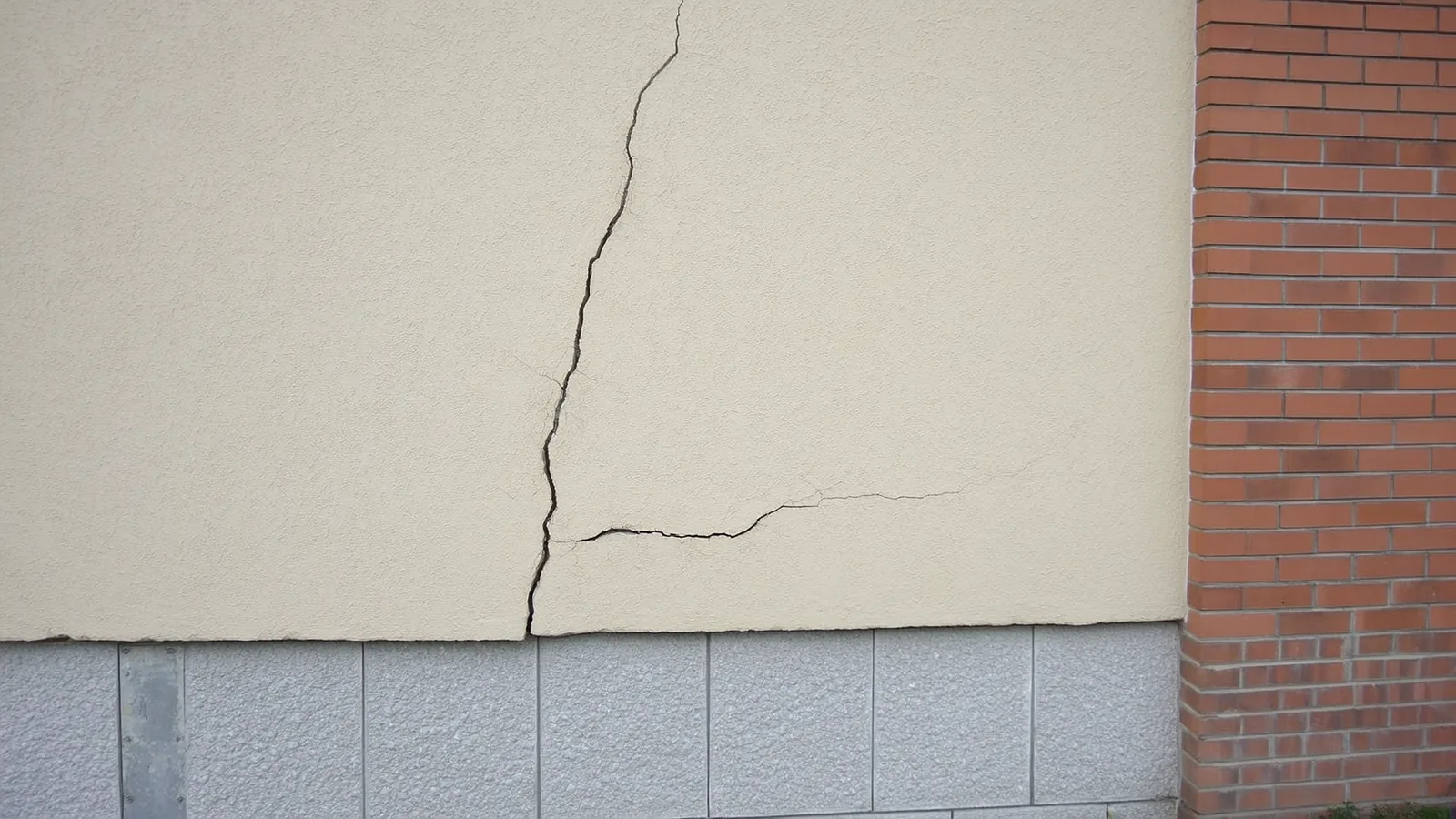 Diagonal stair-step crack running through a concrete block foundation wall in a Knoxville Tennessee home