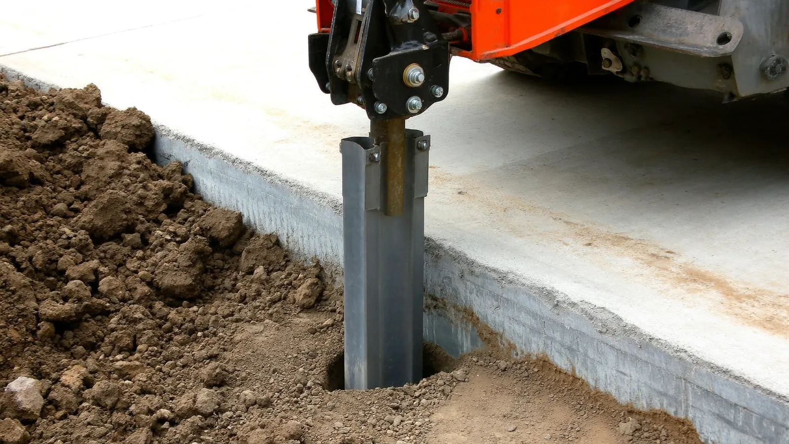 Hydraulic push pier bracket installed on a concrete footing in Knoxville Tennessee during residential foundation underpinning